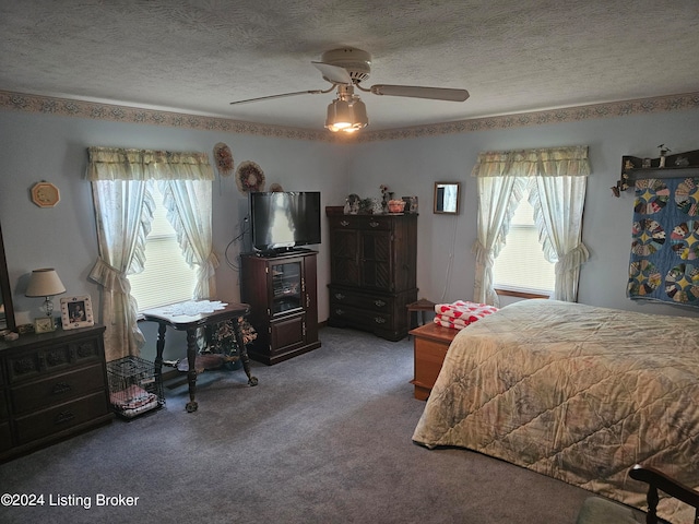 carpeted bedroom with ceiling fan and a textured ceiling