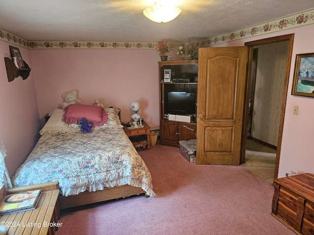 carpeted bedroom with a textured ceiling