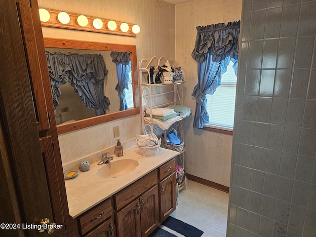 bathroom featuring tile walls, tasteful backsplash, and vanity