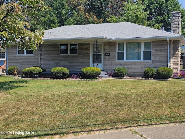 single story home featuring a front lawn