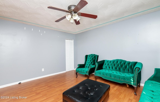 living area featuring ceiling fan and wood-type flooring