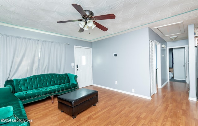 living room featuring light wood-type flooring and ceiling fan