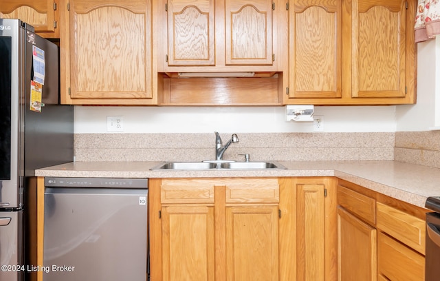 kitchen featuring sink, light brown cabinetry, range, and dishwashing machine