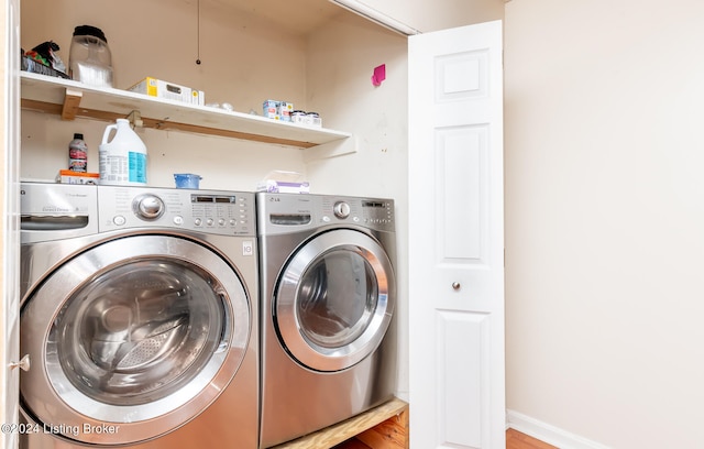 laundry area featuring hardwood / wood-style floors and washer and clothes dryer