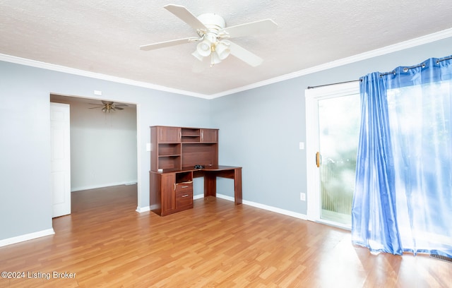 empty room featuring light wood-type flooring, ornamental molding, ceiling fan, and a textured ceiling