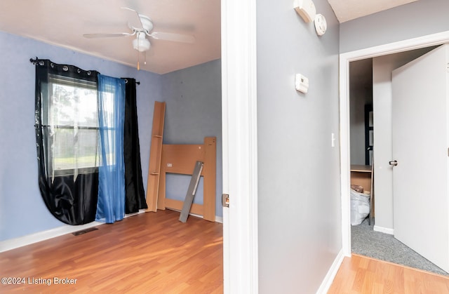 hallway with light hardwood / wood-style floors