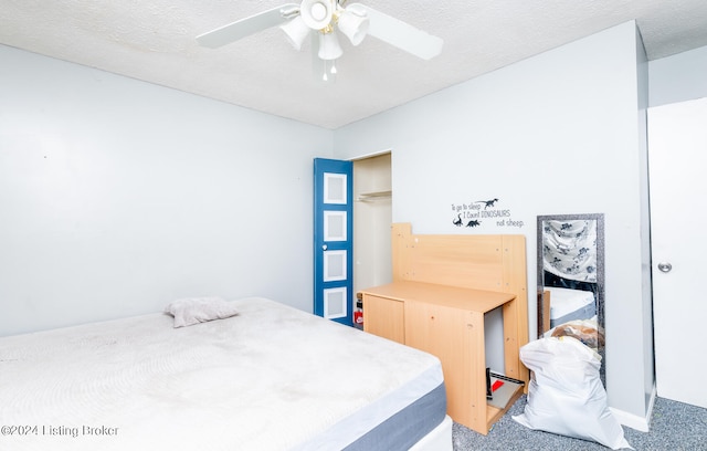 carpeted bedroom featuring a textured ceiling and ceiling fan