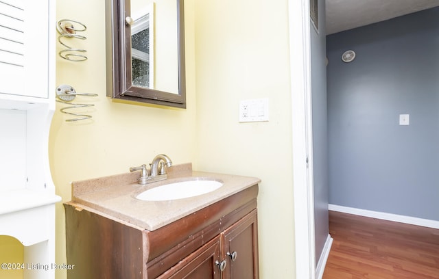 bathroom with vanity and wood-type flooring