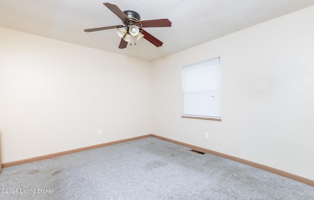 unfurnished room featuring carpet and ceiling fan