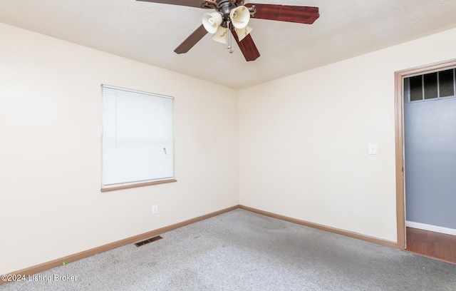 unfurnished room featuring ceiling fan and carpet