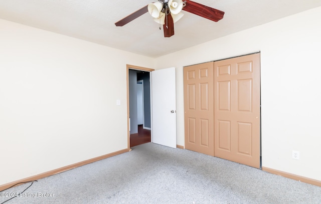 unfurnished bedroom with ceiling fan, carpet, and a closet