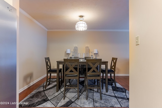 dining room featuring ornamental molding and hardwood / wood-style floors