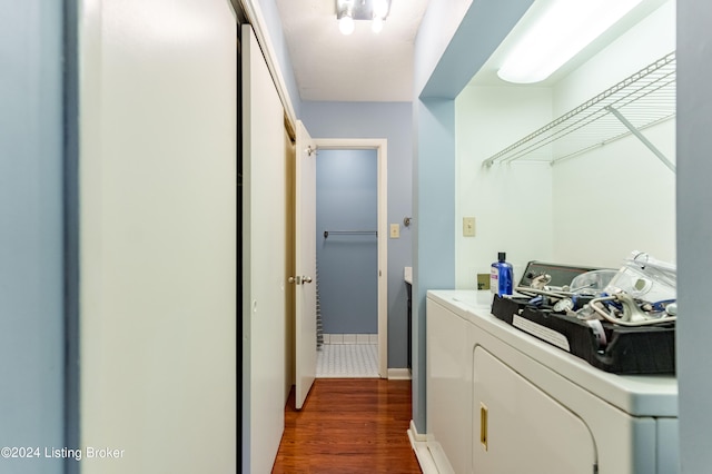 washroom featuring dark hardwood / wood-style flooring and washing machine and clothes dryer