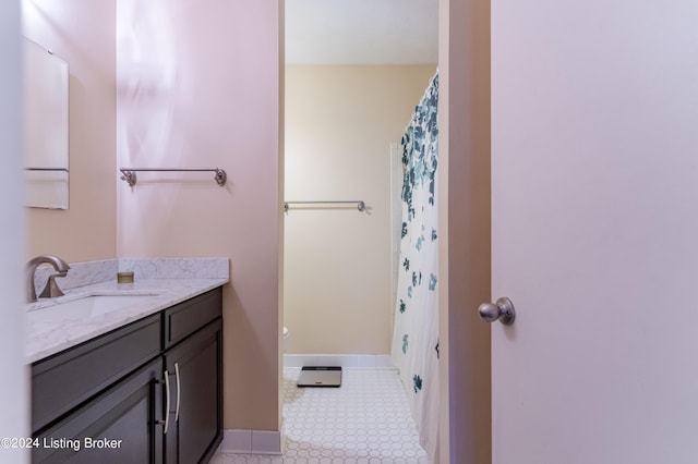 bathroom with walk in shower, vanity, tile patterned flooring, and toilet