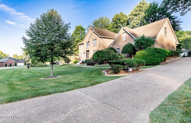 view of side of home with a yard