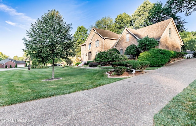 view of home's exterior with brick siding and a lawn