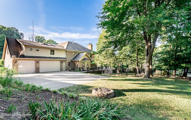 front of property featuring a front yard and a garage