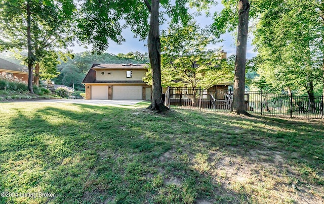 view of front of home with an attached garage, fence, a front lawn, and brick siding