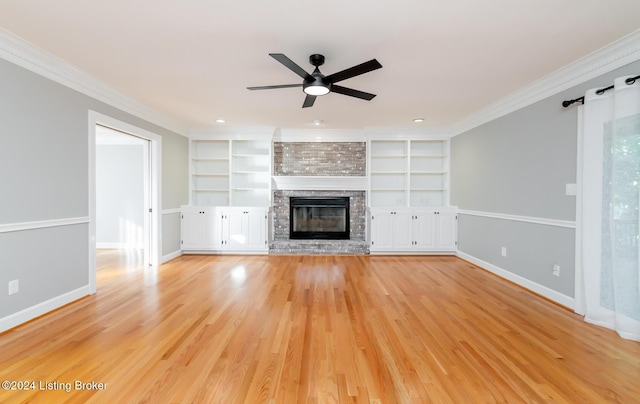 unfurnished living room featuring a brick fireplace, baseboards, ornamental molding, and light wood finished floors