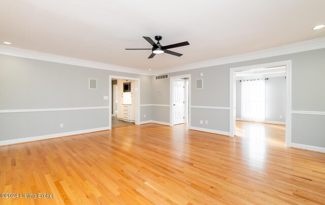 empty room with crown molding, light wood-type flooring, and ceiling fan