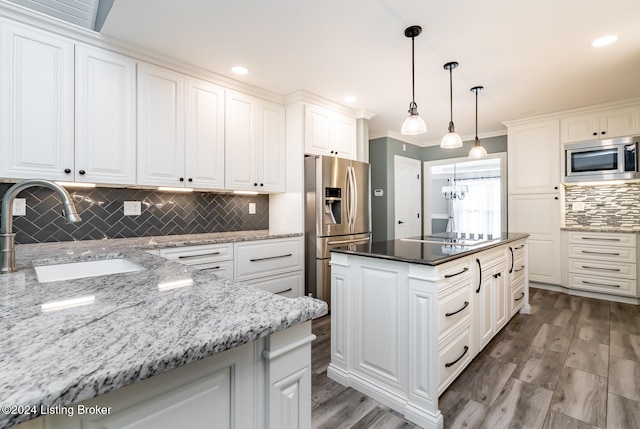 kitchen with sink, appliances with stainless steel finishes, white cabinets, and dark stone counters