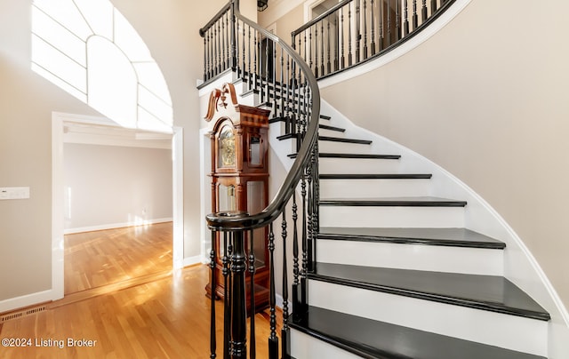 stairs with hardwood / wood-style floors