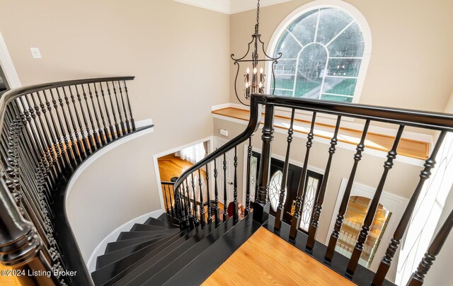 stairway featuring ornamental molding, a chandelier, and french doors