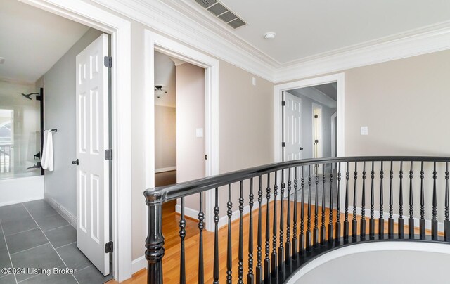 corridor with crown molding and dark hardwood / wood-style flooring