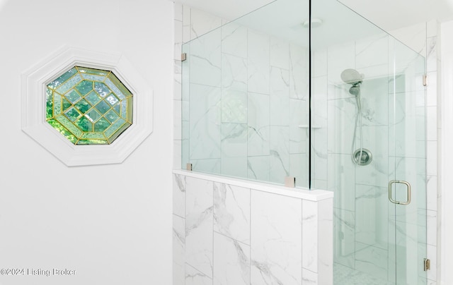 full bathroom featuring a marble finish shower