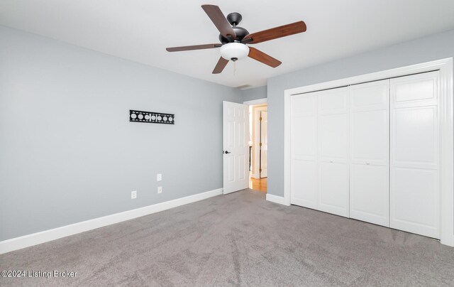 unfurnished bedroom with a closet, ceiling fan, and light colored carpet