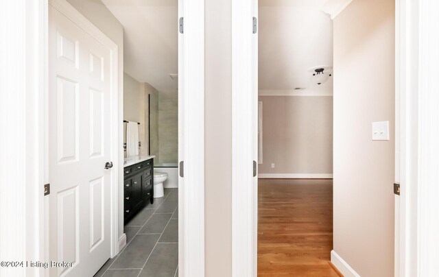 hallway featuring crown molding and dark hardwood / wood-style flooring