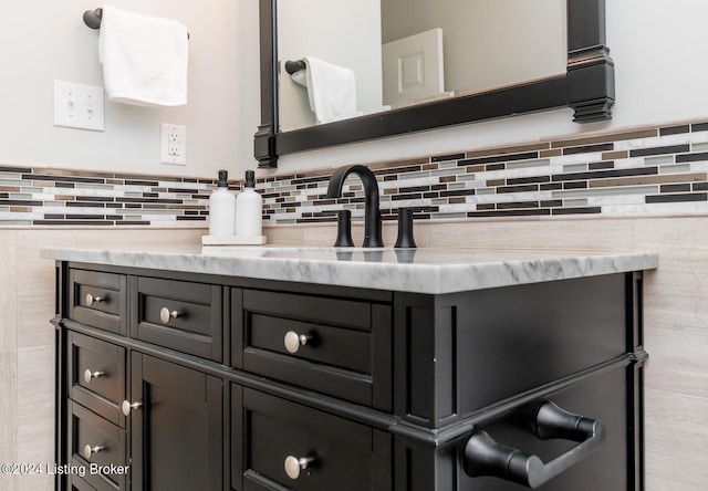 bathroom with vanity and tasteful backsplash