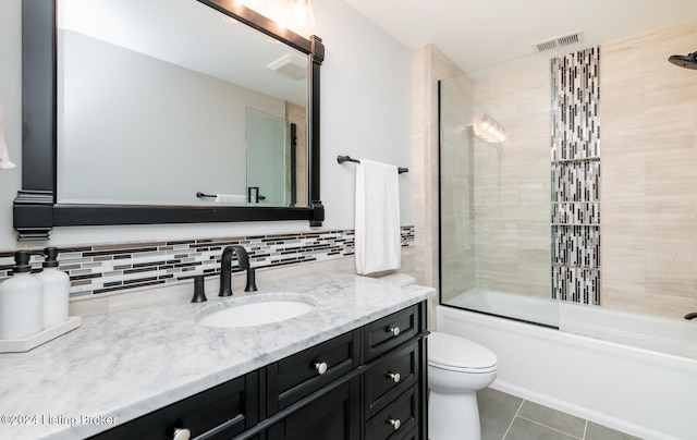 full bathroom with decorative backsplash, bath / shower combo with glass door, toilet, vanity, and tile patterned floors