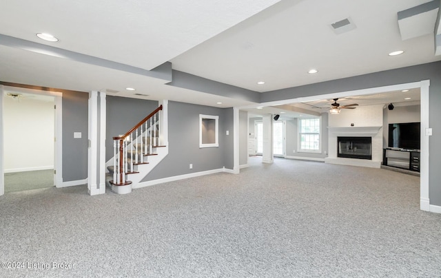 unfurnished living room featuring recessed lighting, carpet floors, a ceiling fan, baseboards, and stairway