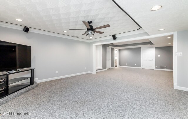 unfurnished living room with carpet floors, crown molding, visible vents, a textured ceiling, and baseboards