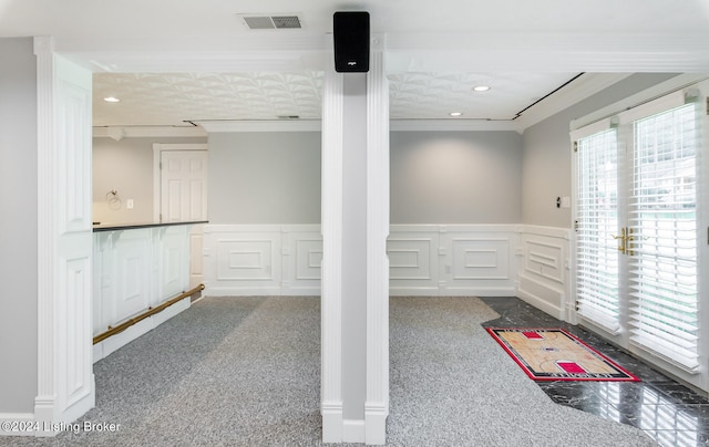 basement featuring crown molding and carpet floors