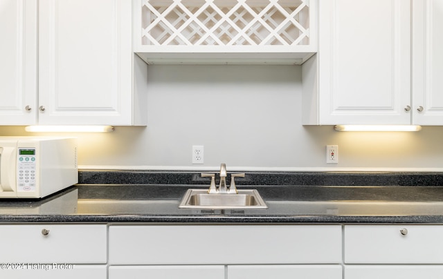 kitchen featuring white cabinets and sink