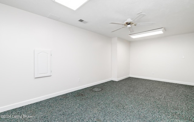 unfurnished room featuring carpet floors, visible vents, baseboards, and a ceiling fan