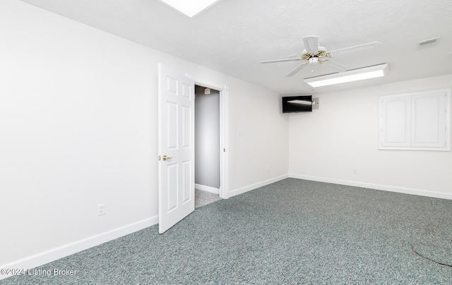 interior space featuring ceiling fan, a textured ceiling, and baseboards