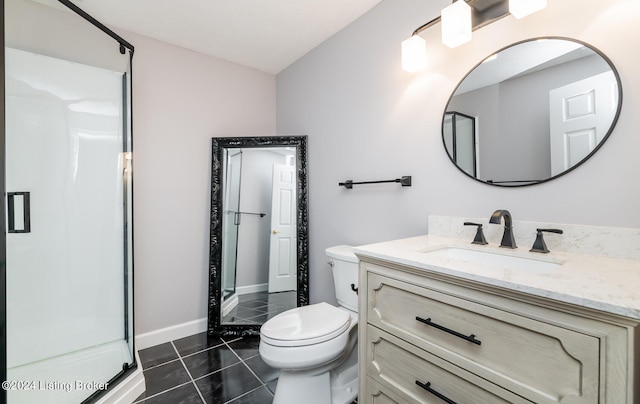 bathroom featuring vanity, a shower with shower door, toilet, and tile patterned floors