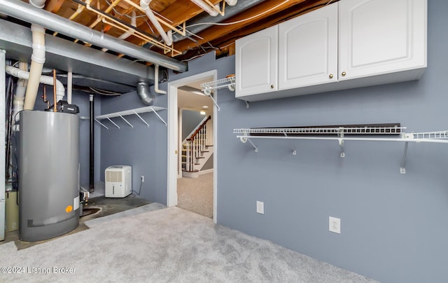 basement with light colored carpet and gas water heater