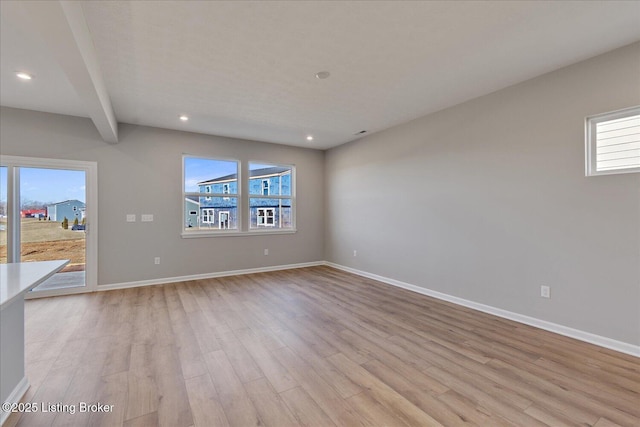 unfurnished living room with a healthy amount of sunlight and light hardwood / wood-style flooring