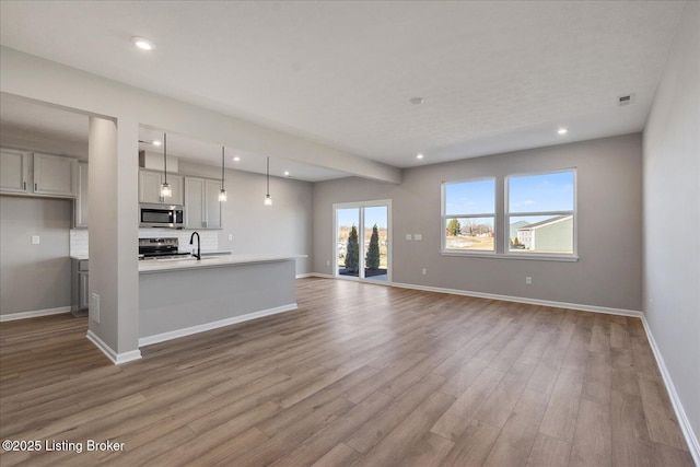 unfurnished living room featuring light wood-type flooring