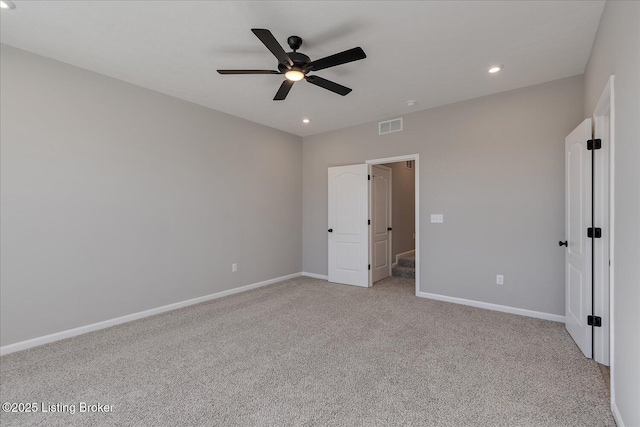 unfurnished bedroom featuring light colored carpet and ceiling fan