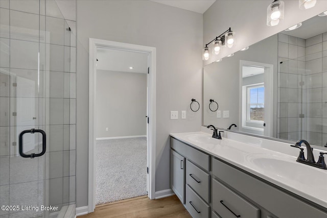 bathroom featuring vanity, hardwood / wood-style floors, and an enclosed shower