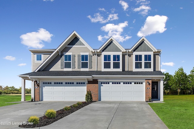 view of front of home with driveway, a front lawn, board and batten siding, an attached garage, and brick siding