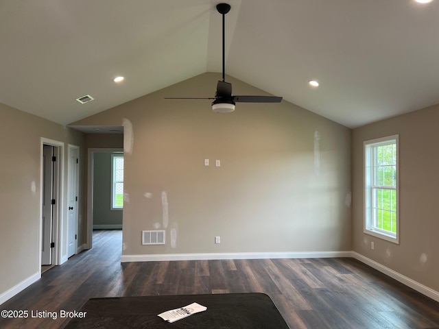 unfurnished room with visible vents, plenty of natural light, a ceiling fan, and vaulted ceiling