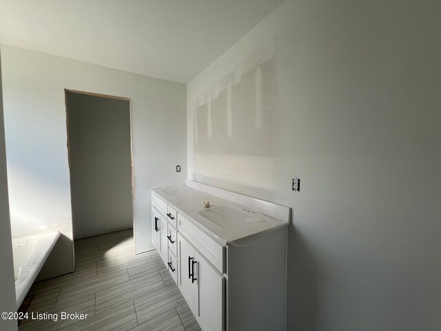 bathroom with a bath and vanity