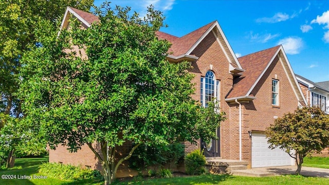 view of front of house featuring concrete driveway, brick siding, an attached garage, and a shingled roof