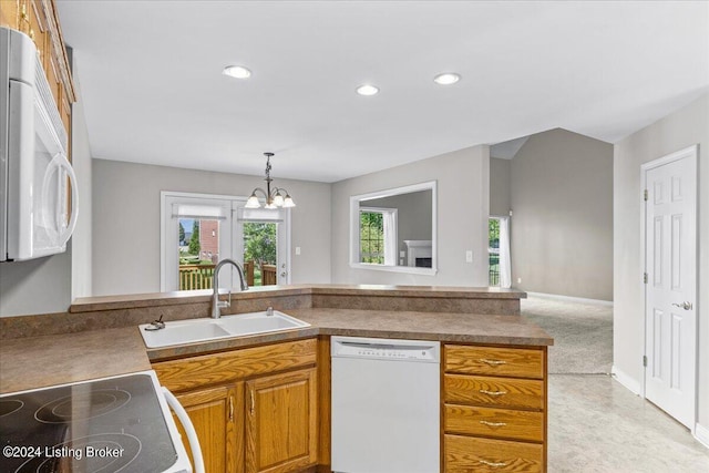 kitchen with recessed lighting, white appliances, a sink, brown cabinetry, and pendant lighting